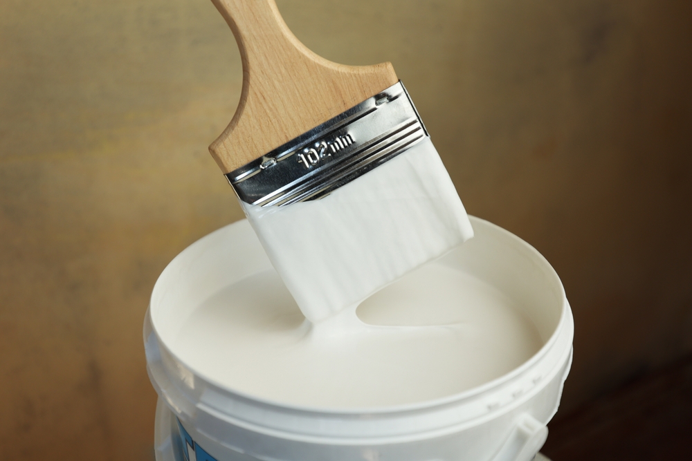 A,Bucket,Of,White,Paint,And,A,Brush.,Painting,Works
